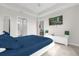 Bedroom featuring a TV, ensuite bathroom access, and modern white furnishings at 3180 Paradox Cir # 304, Kissimmee, FL 34746