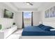Bedroom with TV, tray ceiling, bright window, and comfortable blue bedding at 3180 Paradox Cir # 304, Kissimmee, FL 34746