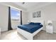 Bedroom featuring a bright window, modern decor, and sleek white furnishings at 3180 Paradox Cir # 304, Kissimmee, FL 34746