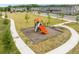 Community playground with a slide and climbing features, surrounded by a large grassy area at 3180 Paradox Cir # 304, Kissimmee, FL 34746