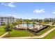 Aerial view of a resort-style pool surrounded by palm trees and modern apartment buildings at 3180 Paradox Cir # 304, Kissimmee, FL 34746