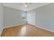 This bedroom features hardwood floors, a ceiling fan, and a window for natural light at 3222 Eagle Creek Ln, Kissimmee, FL 34746