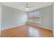 Bedroom featuring wood-look flooring, a ceiling fan, and a window with lots of natural light at 3222 Eagle Creek Ln, Kissimmee, FL 34746