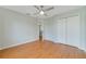 Bedroom featuring wood-look flooring, a ceiling fan, and closet space at 3222 Eagle Creek Ln, Kissimmee, FL 34746
