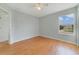 This bedroom has hardwood floors, a ceiling fan, and a window for natural light at 3222 Eagle Creek Ln, Kissimmee, FL 34746