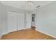 Spacious bedroom includes a ceiling fan, wood-look flooring, and closet at 3222 Eagle Creek Ln, Kissimmee, FL 34746