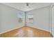 Bright bedroom featuring two windows, ceiling fan, and wood-look flooring at 3222 Eagle Creek Ln, Kissimmee, FL 34746