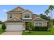 Charming two-story home with a well-manicured lawn and a two car garage at 3222 Eagle Creek Ln, Kissimmee, FL 34746