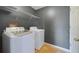 Convenient laundry room features modern washer, dryer, and storage shelving for organization at 3222 Eagle Creek Ln, Kissimmee, FL 34746