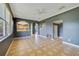 Open-concept living room with tile flooring and views into kitchen and entry at 3222 Eagle Creek Ln, Kissimmee, FL 34746