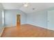 Vaulted ceiling main bedroom with wood-look flooring, and an ensuite bath at 3222 Eagle Creek Ln, Kissimmee, FL 34746