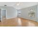 Bright main bedroom featuring wood-look flooring and natural light from two windows at 3222 Eagle Creek Ln, Kissimmee, FL 34746