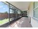 This screened-in patio features brick pavers and views of the yard at 3222 Eagle Creek Ln, Kissimmee, FL 34746