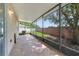 The screened-in patio features brick pavers and views of the yard at 3222 Eagle Creek Ln, Kissimmee, FL 34746