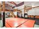 Large basement featuring a wrestling mat, gym equipment, stairs to the second level, and natural light at 3461 Michigan St, Lake Mary, FL 32746