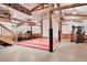 Finished basement features exercise equipment, wooden stairs, high ceilings, and a wrestling mat at 3461 Michigan St, Lake Mary, FL 32746