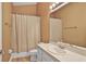 Bathroom featuring single vanity, a standard shower and wood look vinyl flooring at 3461 Michigan St, Lake Mary, FL 32746