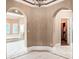 Elegant primary bath with arched entries, white tile floors, jetted tub, and walk-in closet at 3461 Michigan St, Lake Mary, FL 32746