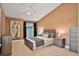 Inviting bedroom boasts tray ceilings, large window and stylish neutral furniture at 3461 Michigan St, Lake Mary, FL 32746
