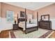 Elegant bedroom with four-poster bed, neutral palette, and ample natural light at 3461 Michigan St, Lake Mary, FL 32746