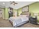 Bedroom with green walls, a tufted headboard, and dark wood furniture at 3461 Michigan St, Lake Mary, FL 32746
