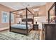 Sophisticated bedroom featuring a four-poster bed, dresser, and classic decor at 3461 Michigan St, Lake Mary, FL 32746