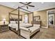 Primary bedroom with a four-poster bed, sitting bench, and neutral tones at 3461 Michigan St, Lake Mary, FL 32746