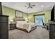Spacious bedroom with green walls, a tufted headboard, and a ceiling fan at 3461 Michigan St, Lake Mary, FL 32746