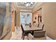 This dining room features a tray ceiling and a view through the french doors to the exterior of the home at 3461 Michigan St, Lake Mary, FL 32746