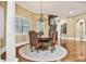 Dining room with spiral staircase, hardwood floors, and large windows at 3461 Michigan St, Lake Mary, FL 32746