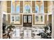 Grand foyer featuring high ceilings, large windows, ornate doors, and a black and white checkered marble floor at 3461 Michigan St, Lake Mary, FL 32746