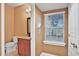 A half bathroom features a window and a granite countertop on the vanity and neutral wall paint at 3461 Michigan St, Lake Mary, FL 32746