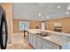 Open kitchen with stainless steel sink, white appliances and a view into the adjacent living space at 3461 Michigan St, Lake Mary, FL 32746