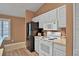 Well-lit kitchen features modern appliances, white cabinetry, and wood-look flooring at 3461 Michigan St, Lake Mary, FL 32746