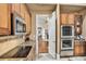 View from kitchen with stainless steel appliances looking into an arched hallway at 3461 Michigan St, Lake Mary, FL 32746
