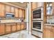 Kitchen with stainless steel appliances, custom cabinetry, and a tiled backsplash at 3461 Michigan St, Lake Mary, FL 32746
