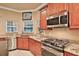 A kitchen with cherry cabinets features granite counters and stainless steel appliances at 3461 Michigan St, Lake Mary, FL 32746