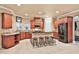 The kitchen is finished with cherry cabinets, dark countertops, and a kitchen island with seating at 3461 Michigan St, Lake Mary, FL 32746