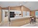 Bright kitchen with white cabinetry, a black refrigerator and an adjacent dining area at 3461 Michigan St, Lake Mary, FL 32746