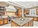 Kitchen featuring an island, range hood, and stainless steel appliances at 3461 Michigan St, Lake Mary, FL 32746