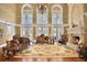 Bright living room with fireplace, chandelier, and three large windows at 3461 Michigan St, Lake Mary, FL 32746