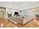 Open-concept living area with fireplace, television, and oversized sectional at 3461 Michigan St, Lake Mary, FL 32746
