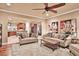 This living room has hardwood floors, neutral-colored walls, and an open view to the kitchen area at 3461 Michigan St, Lake Mary, FL 32746