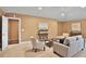 Cozy living room featuring neutral furniture, a modern ceiling fan and warm neutral paint at 3461 Michigan St, Lake Mary, FL 32746