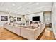 Spacious living room with a large sectional sofa, fireplace, and wood flooring at 3461 Michigan St, Lake Mary, FL 32746