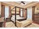 A main bedroom boasts a four-post bed frame, hardwood floors, and neutral wall colors at 3461 Michigan St, Lake Mary, FL 32746