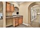 Wet bar with granite countertops, wood cabinetry, and convenient access to other living spaces at 3461 Michigan St, Lake Mary, FL 32746