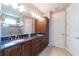 Bathroom with a double vanity, granite countertops, tile floors, and a glass-enclosed shower at 3651 Nw 56Th Ave, Ocala, FL 34482