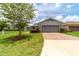 Charming home with a brick driveway, well-manicured lawn, and professional landscaping at 3651 Nw 56Th Ave, Ocala, FL 34482