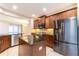 Gourmet kitchen featuring stainless steel appliances, a center island, and dark wood cabinetry at 3651 Nw 56Th Ave, Ocala, FL 34482